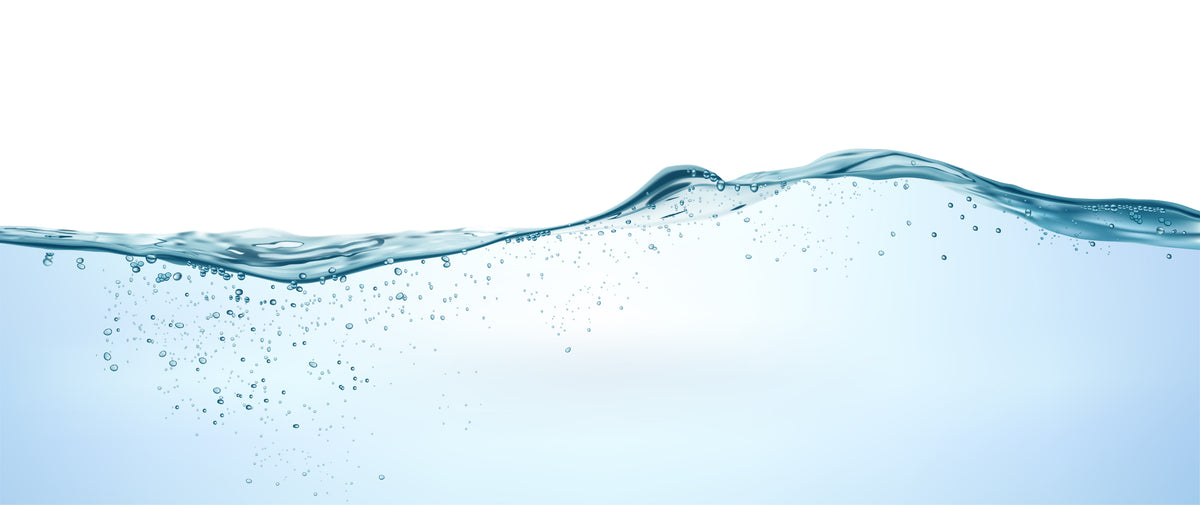 Clear blue water wave with rising bubbles representing clean drinking water verified by Kleer Blue Water testing.