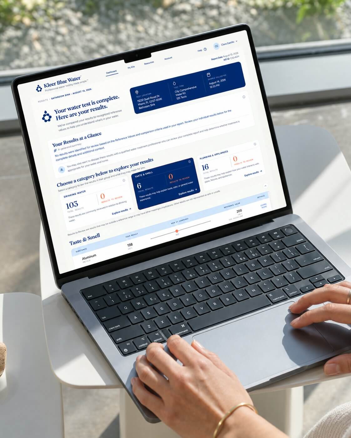Person viewing Kleer Blue Water water test results on a laptop dashboard